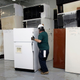 An environmental worker recycles an old refrigerator at a recycling plant August 12, 2009 in Livonia, Michigan.